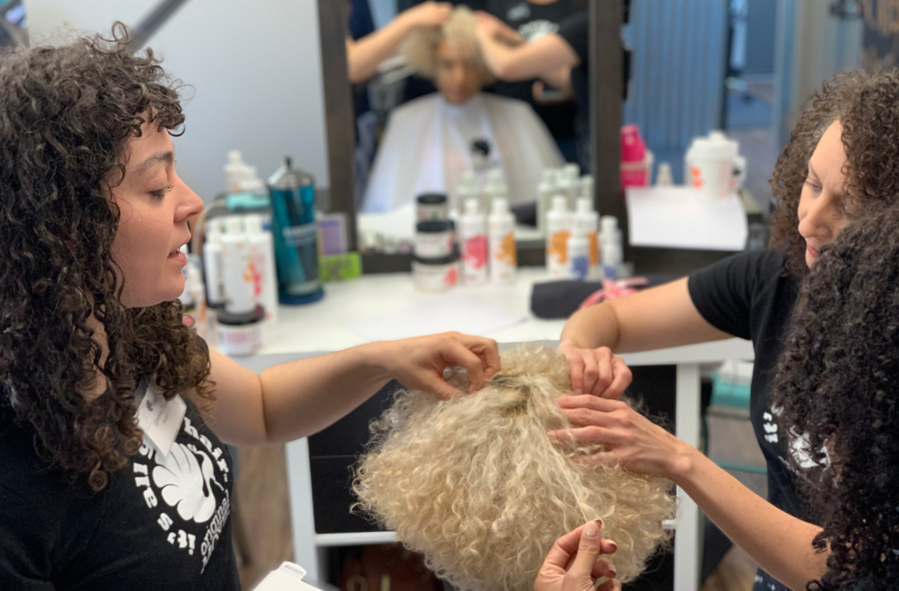 Hairstylists touching a client's hair