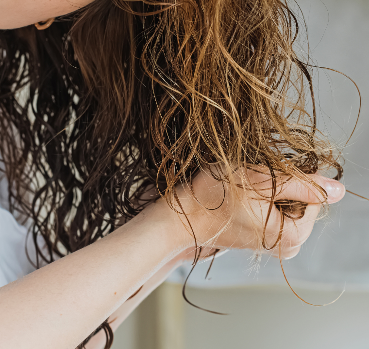 Person scrunching product into their hair