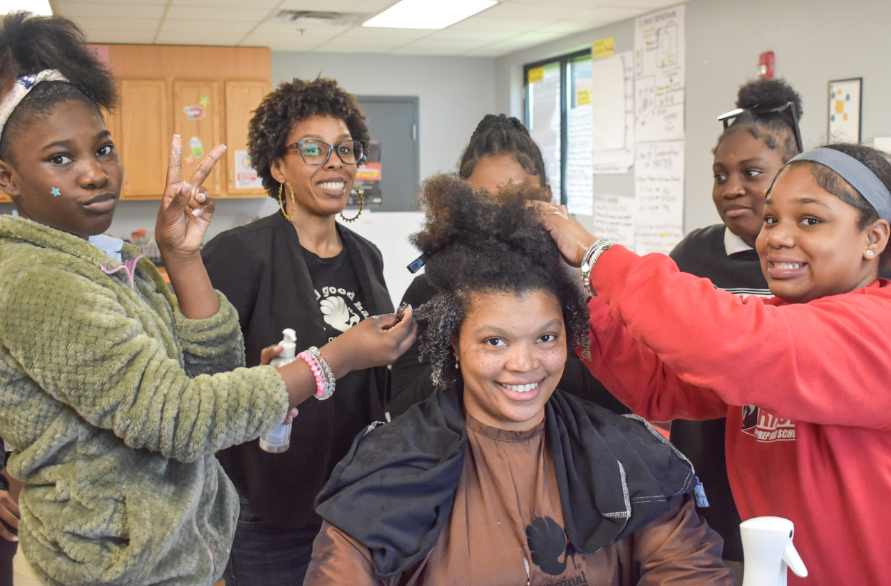 School students receive a hands-on learning experience about curly hair