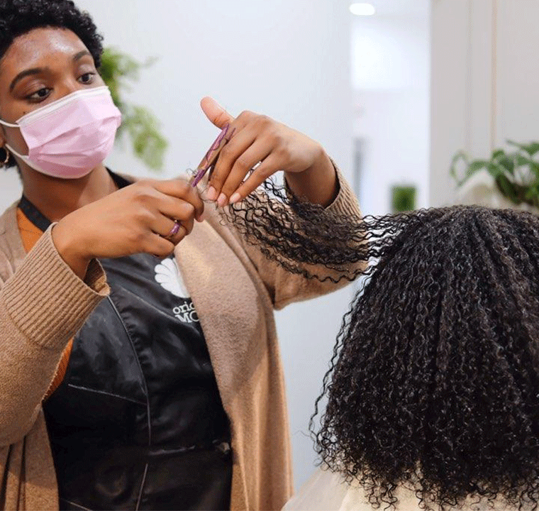 Stylist cutting curly hair