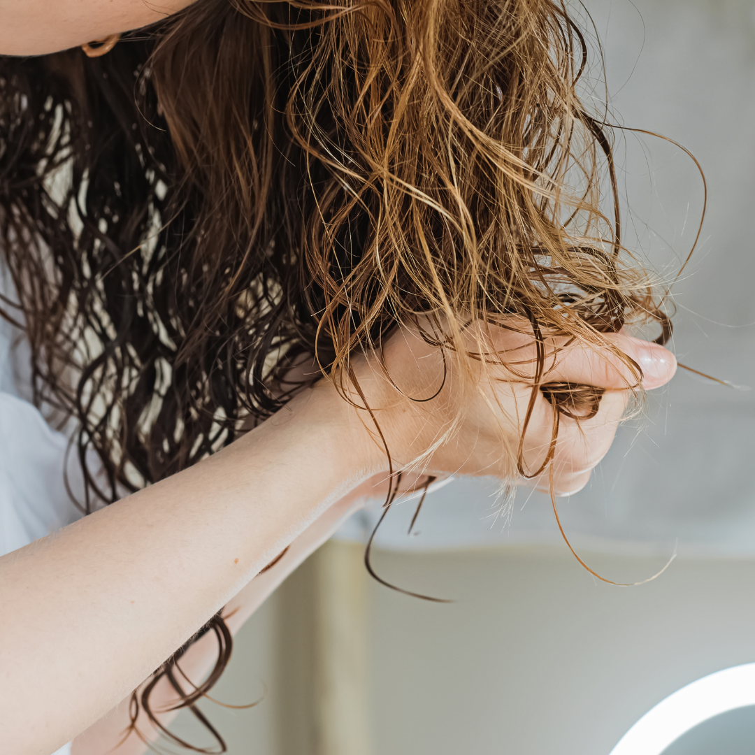 Woman scrunching product into the hair